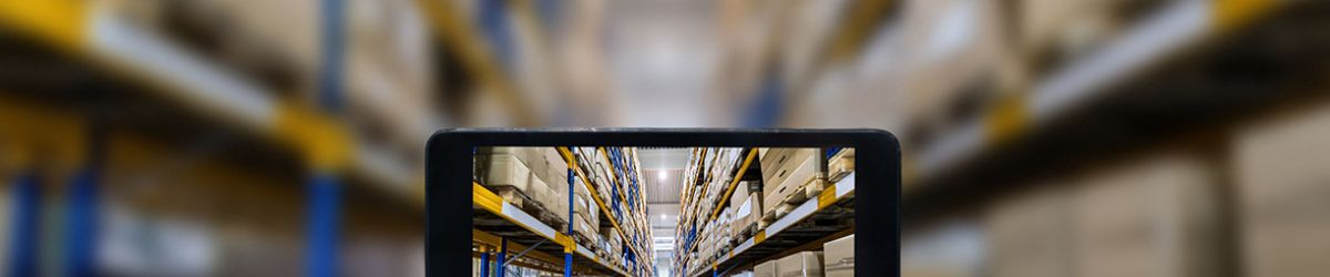 Woman holding up a tablet in a warehouse